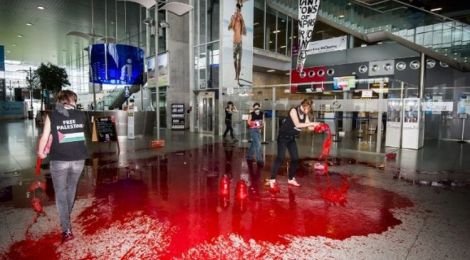 Belgian women pour fake blood in airport to protest Israel arms transport